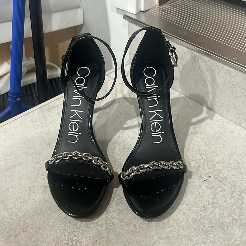 Black Calvin Klein Heels with a Chain on front